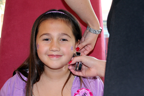 Girl showcasing kids ear piercing services from Sweet & Sassy team member