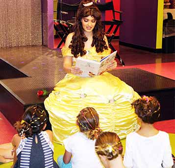 Princess reading book to kids during princess party